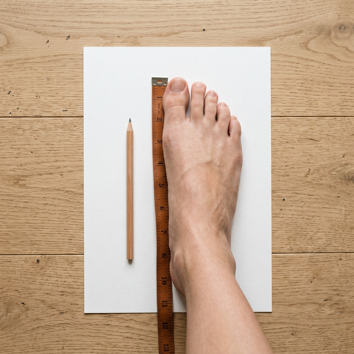 Measuring a bare foot with a tape measure for made-to-fit shoes